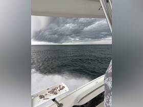 A dramatic view of stormy clouds looming over the ocean, captured from the deck of a boat — a striking scene showcasing nature's power at sea.
