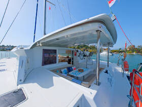 A spacious and stylish interior of a catamaran featuring comfortable seating and a well-equipped helm, perfect for relaxing and navigating the waters.