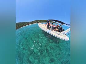A lively group enjoys a day on the water aboard a boat, surrounded by stunning clear waters and a picturesque beach backdrop — perfect for summer adventures.