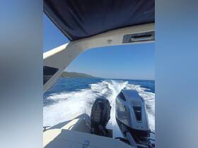 A view from the helm of a boat cruising through clear waters, showcasing the powerful engines and scenic coastline.