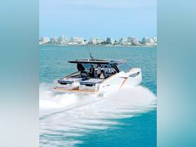 A stylish yacht speeds through turquoise waters with a group of guests enjoying the ride, showcasing the perfect blend of luxury and adventure on the water.