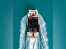 A stunning aerial view of a sleek yacht cruising through crystal-clear turquoise waters, showcasing its elegant design and smooth wake.