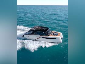 A stunning aerial view of a sleek catamaran cruising through vibrant turquoise waters, showcasing its modern design and performance.