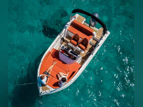 A couple enjoys a relaxing moment on a stylish boat, surrounded by stunning turquoise waters — perfect for a day of leisure on the sea.