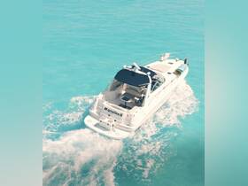 A stunning aerial view of the yacht 'Manateell' cruising through crystal-clear turquoise waters, perfect for luxury charters and island adventures.