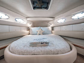 Cozy cabin interior featuring a comfortable bed and stylish decor, perfect for relaxing on a boat getaway.