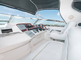 A sleek and modern helm area of a boat, featuring white leather seating and advanced navigation equipment, perfect for a comfortable and stylish boating experience.