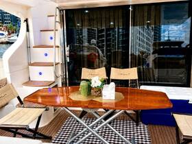 A beautifully arranged interior of an Azimut yacht featuring a dining area with elegant seating and decor, perfect for relaxing and entertaining on the water.