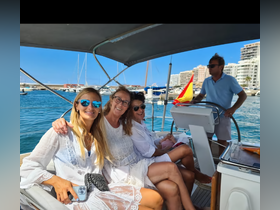A joyful group of friends enjoys their time aboard a boat, capturing the essence of fun and camaraderie on the water.