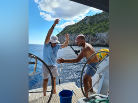 Two friends celebrate a successful fishing catch aboard a boat, enjoying the thrill of the ocean and camaraderie.