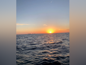 A stunning sunset over the ocean, capturing the serene beauty of the water and sky — perfect for romantic evenings or peaceful boat rides.