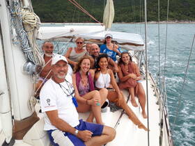 A cheerful group of friends enjoys a sailing adventure, capturing the joy of togetherness on the water.
