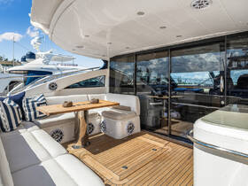 A beautifully designed interior lounge area of a yacht featuring comfortable seating and a stylish table, perfect for relaxing and entertaining on the water.