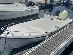 A clean and simple view of a small boat docked at the marina, showcasing its sleek design and readiness for a day on the water.