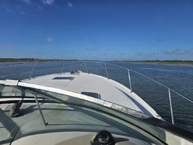 A clear view from the front of a boat navigating through calm waters, showcasing the serene landscape and blue skies — perfect for a day of exploration on the water.