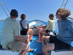 A group of friends enjoys a boat ride, taking in the scenic views while seated comfortably. Perfect for adventure seekers looking to explore the waters together.