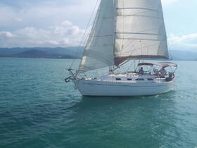 A beautiful sailboat glides through turquoise waters, showcasing a perfect day for sailing adventures.
