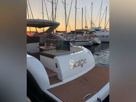 The elegant back view of the 'Scape' yacht docked at sunset, showcasing its luxurious design and inviting atmosphere, perfect for upscale boating experiences.