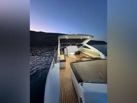 An inviting interior view of a sleek boat, showcasing comfortable seating and a well-equipped helm, perfect for relaxing on evening cruises.
