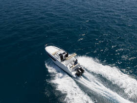 A sleek speedboat navigates through vibrant blue waters, showcasing an exhilarating day on the sea.