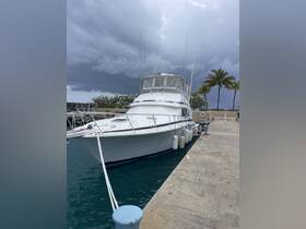A sleek yacht docked at the marina under a dramatic sky, showcasing its elegant design and readiness for the next adventure.