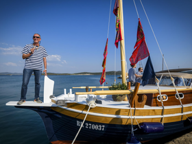 A cheerful group enjoys a sunny day on a beautifully decorated boat, perfect for celebrations and gatherings on the water.