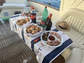 A beautifully arranged spread of snacks and drinks on a boat, perfect for enjoying a relaxing day on the water with friends or family.
