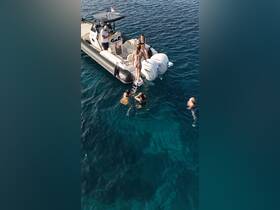 A lively group enjoys a refreshing swim in crystal-clear waters, with a boat nearby, perfect for summer adventures and water activities.