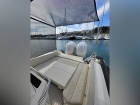 A spacious and stylish interior view of a boat's seating area, showcasing comfortable cushions and a serene marina backdrop — perfect for relaxing on the water.