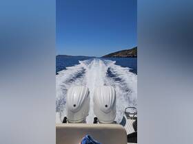 A dynamic view of a speedboat in motion, showcasing the powerful engines and the wake created in the clear blue waters, perfect for thrilling boating adventures.