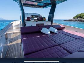 A stylish lounge area on a luxury boat, featuring plush seating and a serene view of the turquoise waters — perfect for relaxation and enjoying the sun.