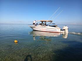 A motorboat navigates through crystal-clear waters, showcasing a perfect day for boating adventures.