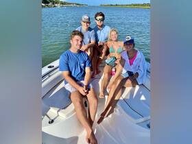A group of friends enjoys a sunny day on the boat, capturing the essence of summer fun and relaxation on the water.