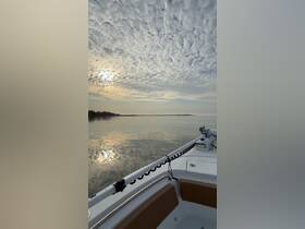 A serene view from the bow of a boat, capturing the tranquil waters and a beautiful cloud-filled sky at sunset — perfect for peaceful evening cruises.