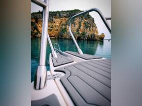A serene view of a boat's deck with stunning rocky cliffs in the background, showcasing the tranquil waters ideal for exploration.