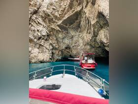 A scenic view of boats navigating through a stunning cave, showcasing the beauty of marine exploration and adventure.