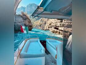 Interior view of a boat showcasing comfortable seating as it navigates through stunning rocky landscapes, perfect for enjoying scenic cruises.