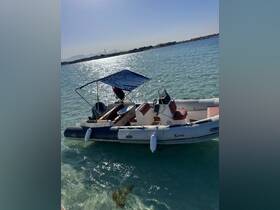 A sleek speedboat named 'Kew' anchored in clear turquoise waters, showcasing its stylish design and perfect for a day of adventure on the water.