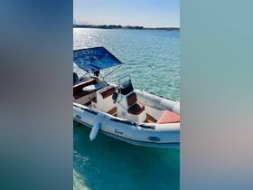 A sleek speedboat named 'Kew' docked in clear turquoise waters, showcasing its inviting seating and stylish design, perfect for a day on the water.