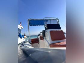 A close-up view of the helm and seating area inside a boat, showcasing the comfortable design and layout ideal for a day on the water.