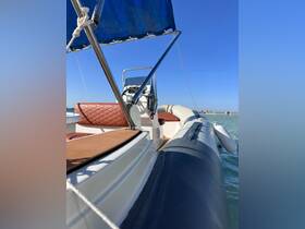 A close-up view of the helm and seating area of a stylish boat, showcasing its comfortable design and inviting atmosphere for a day on the water.