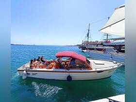 A lively group enjoys a day on the water aboard a boat, surrounded by beautiful scenery and other vessels — perfect for a fun outing with friends.