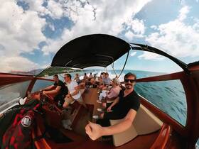 A lively group enjoys a boat ride, capturing the fun atmosphere and scenic views — perfect for memorable outings on the water.