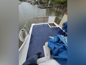 A view from the deck of a boat showing the interior space, including seating and equipment, perfect for relaxing or navigating the waterways.