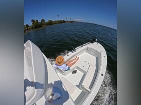A person relaxes on the deck of a boat, enjoying a sunny day on the water — perfect for leisure and exploration.