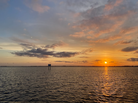 A stunning sunset over tranquil waters, capturing the serene beauty of the evening sky — perfect for romantic boat outings or peaceful reflections.