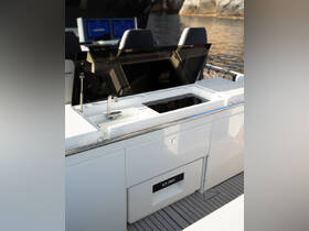 A sleek onboard kitchen area featuring cooking equipment and a sink, perfect for preparing meals while enjoying time on the water.