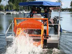 A group of individuals enjoys a unique boating experience on a specialized vessel, showcasing both adventure and camaraderie on the water.