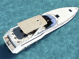 A stunning aerial view of a sleek speedboat gliding through crystal-clear waters, perfect for luxury outings or island hopping adventures.