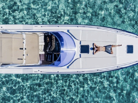 An aerial view of a person sunbathing on a boat, surrounded by crystal-clear waters — a perfect scene for relaxation and summer adventures on the water.